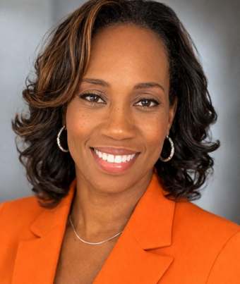 Felecia Saunders, smiling, in an orange blazer